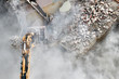 © MaciejBledowski - Building demolition with an excavator in dust cloud.
