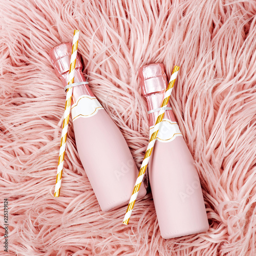 Fotografie, Obraz Champagne bottles on pink fluffy fur background