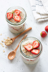 overnight oatmeal or strawberry overnight oats in a jar on concrete background. selective focus, hea
