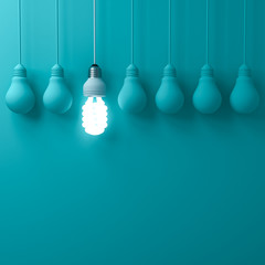 Fototapete - One hanging eco energy saving light bulb glowing and standing out from unlit incandescent bulbs on dark green pastel color wall background leadership and different creative idea concepts 3D rendering
