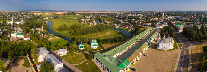 Wall Mural - Beautiful panoramic view of Suzdal in summer at sunrise. Resurrection Church on the market square in Suzdal. Suzdal is a famous tourist attraction and part of the Golden Ring of Russia