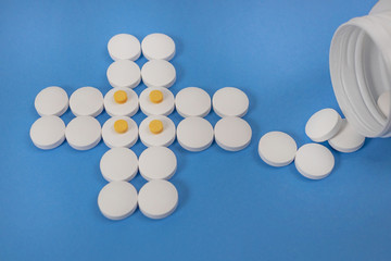 white pill cross on blue background