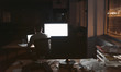 Businessman working online at his desk in a dark office