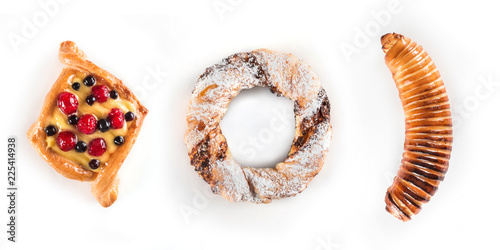 Fotografie, Obraz Fresh and tasty berry cake, a pretzel with sugar powder and banana in dough isol