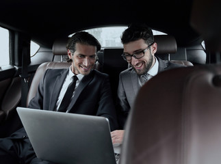 Wall Mural - two businessman talking while sitting in the car