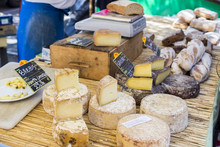 Rustic Table Of French Cheeses At A Market In Arles, Provence, France