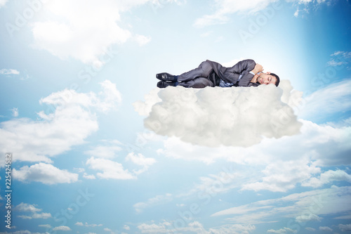 Fototapeta Young male businessman enjoying his time during vacation