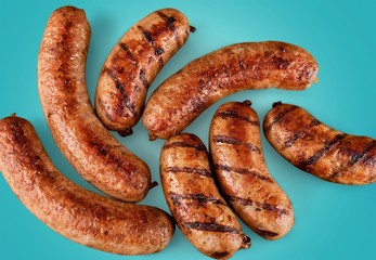 Wall Mural - Roasted sausages on white background