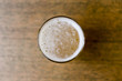 Glass of beer on the wooden table with copyspace, top view