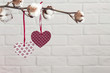 Dried cotton branch with two red paper hearts, Valentine's Day conception. Copy space