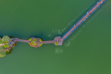 Wall Mural - aerial top view walking bridge in the river on island in the park