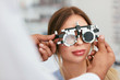 © puhhha - Eye Exam. Woman In Glasses Checking Eyesight At Clinic