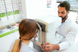 © puhhha - Eye Test. Optometrist Testing Woman Eyesight On Modern Equipment
