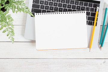 Wall Mural - blank white notebook on laptop computer on wood table