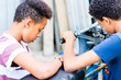 © Kzenon - Close-up of two male friends looking at vintage motorcycle