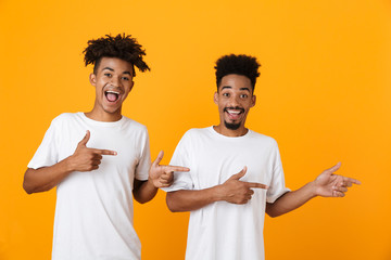 Canvas Print - Two happy male african friends in t-shirts standing