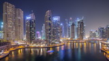 Fototapeta Nowy Jork - Water canal on Dubai Marina skyline at night timelapse.