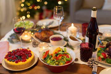 christmas dinner and eating concept - food and drinks on table at home