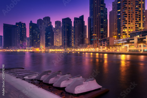 Obraz Dibond Beautiful view to Dubai Marina Promenade, UAE. Long exposure time lapse effect in the dusk