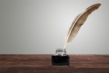 Feather Quill Pen And Glass Inkwell Isolated
