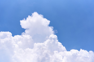 Wall Mural - white puffy cumulus cloud on blue sky as background