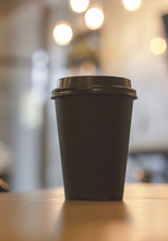 Black Cup With Coffee To Take Away On Bokeh Background, Mock Up