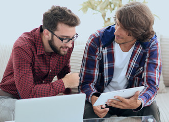 creative web designers working with a tablet and a laptop.