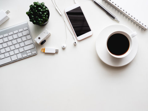 top view of office desk workspace with notebook, smartphone and gadget on white background with copy space, graphic designer, Creative Designer concept.