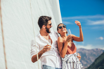 Couple in love on a sail boat in the summer.