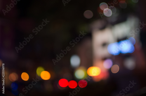 Fotografía Abstract city night defocused light, blur bokeh, colorful & dark background