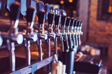 Fototapeta  - Beer taps in beer bar