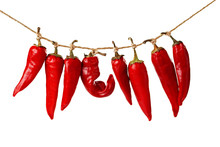 Closeup Of Red Chili Peppers Hanging  On A Rope Isolated On White Background