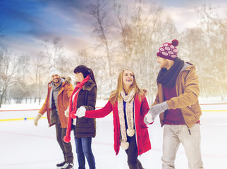 Sticker - people, friendship and leisure concept - happy friends on skating rink outdoors