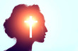 © primipil - Symbol of Christianity concept. Woman silhouette and the Cross.