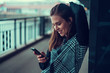 © SVP Productions - Beautiful young brunette looking at her phone under the bridge