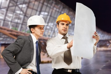 Two engineers men at construction site watching