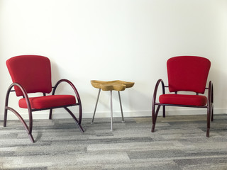 Modern wooden table and two comfortable armchairs.