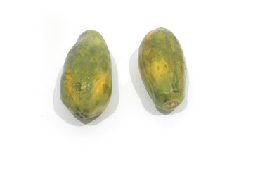 two fresh papaya fruits on a white background