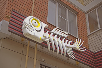 Two mock ups of restaurant street black signboards on yellow wall