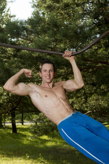 Wall Mural - Handsome Muscular Young Man Workout In The Park