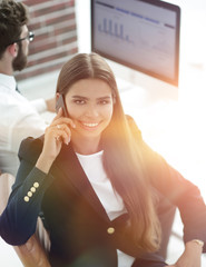 Canvas Print - female employee talking on a mobile with a client