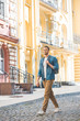 © LIGHTFIELD STUDIOS - young traveller with backpack walking by street and looking at camera