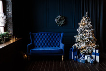 Decorated Dark Blue Living Room With Beautiful Christmas Tree And Cozy Velvet Sofa