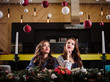 © cherry_d - Pretty twins young women together in a kitchen room, casual home style, new year and christmas decorations