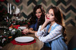 © cherry_d - Pretty twins young women together in a kitchen room, casual home style, new year and christmas decorations