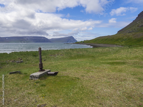 View On Adalvik Cove With Rusty Water Pump And Summer Cottages At
