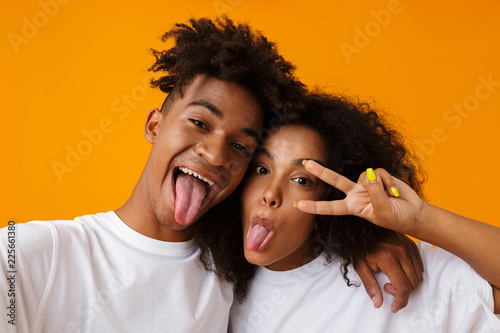 Cute African Couple Posing Isolated Over Beige Background Showing