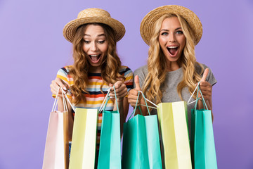 Two pretty happy young girls friends in summer hats