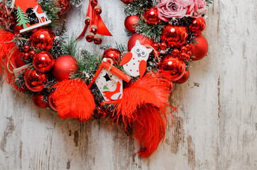 Wall Mural - Christmas Wreath decorated with red balls, feathers and toy houses