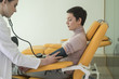 © LStockStudio - Doctor Measuring Blood Pressure
